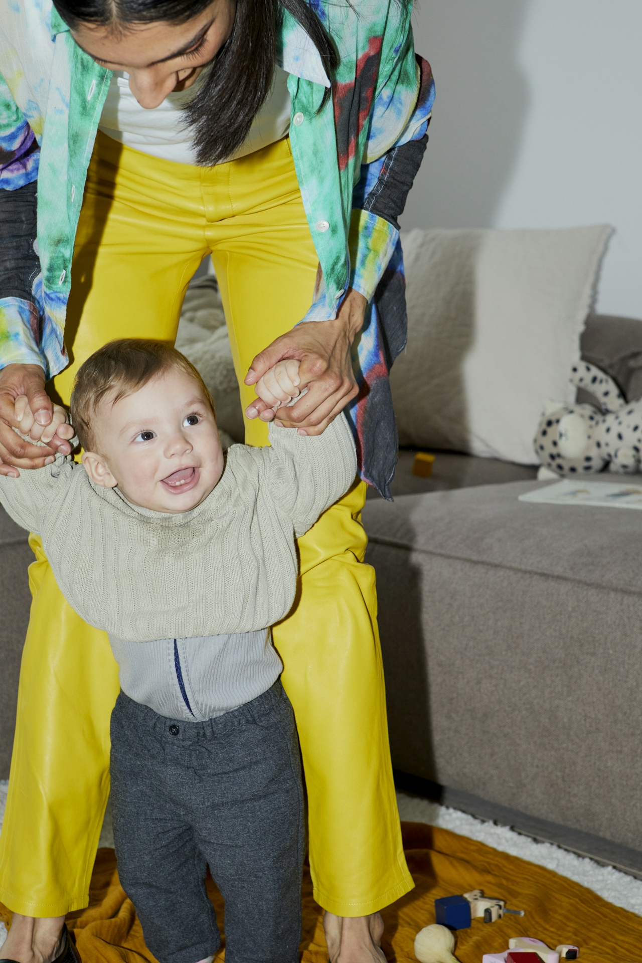 Mother helping a young child take steps