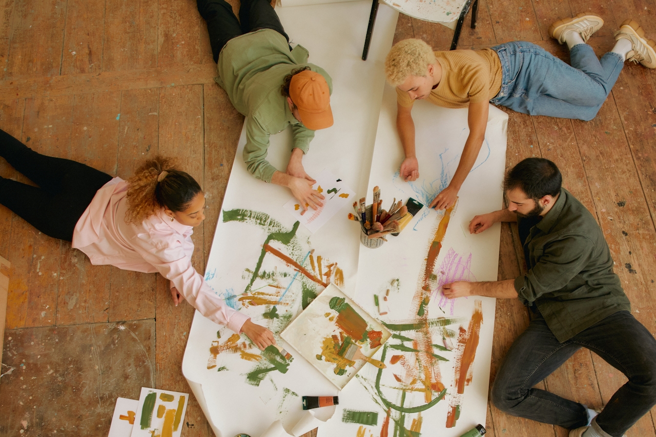Community members collaborating on a shared painting